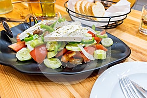 Greek salad with fresh vegetables, feta cheese and black olives