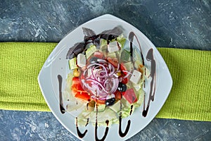 Greek salad with fresh vegetables, feta cheese and black olives