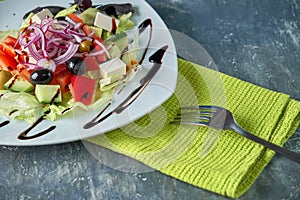 Greek salad with fresh vegetables, feta cheese and black olives