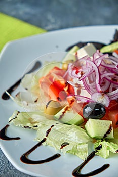 Greek salad with fresh vegetables, feta cheese and black olives