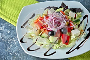 Greek salad with fresh vegetables, feta cheese and black olives