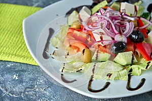 Greek salad with fresh vegetables, feta cheese and black olives