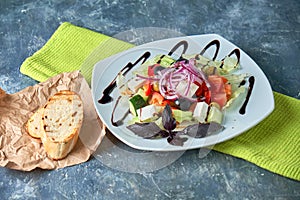 Greek salad with fresh vegetables, feta cheese and black olives