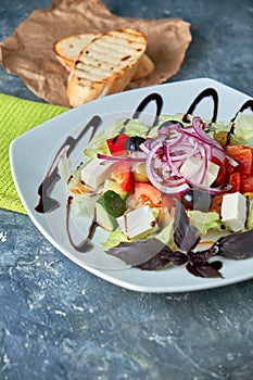 Greek salad with fresh vegetables, feta cheese and black olives