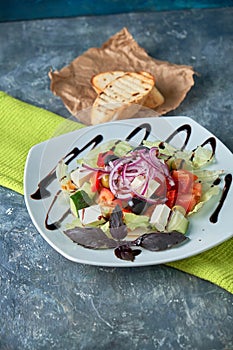 Greek salad with fresh vegetables, feta cheese and black olives