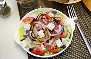 Greek salad with fresh vegetables, feta cheese and black olives