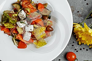 Greek salad with fresh vegetables, feta cheese and black olives