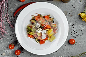 Greek salad with fresh vegetables, feta cheese and black olives