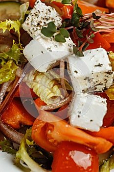 Greek salad with fresh vegetables, feta cheese and black olives