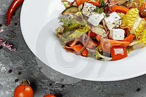 Greek salad with fresh vegetables, feta cheese and black olives