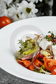 Greek salad with fresh vegetables, feta cheese and black olives