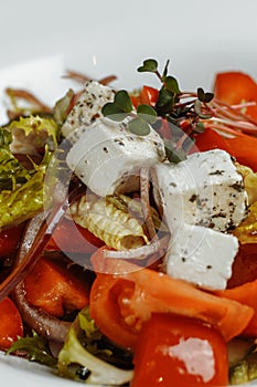 Greek salad with fresh vegetables, feta cheese and black olives