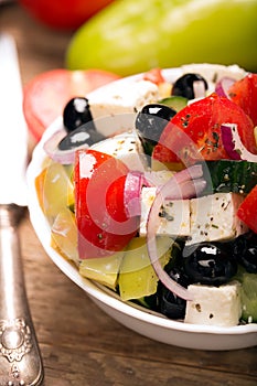 Greek salad with fresh vegetables, feta cheese and black olives. Close up