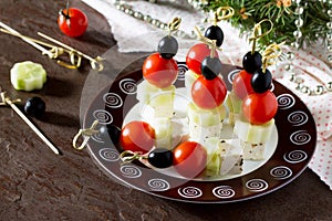 Greek salad with fresh vegetables, feta cheese and olives. Appetizer canape