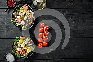 Greek salad with fresh vegetables, feta cheese and olives, on black wooden table background, top view flat lay  with copy space