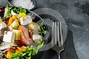 Greek salad with fresh vegetables, feta cheese and olives, on gray background