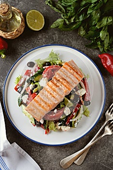 Greek salad with grilled salmon. Healthly food.