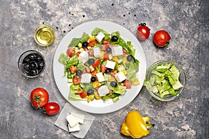 Greek salad with Ingredients on table.