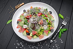 Greek salad with olive oil, fresh vegetables, olives and fetta cheese