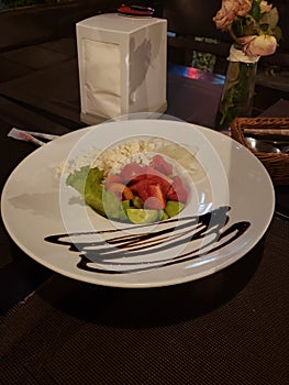 Greek salad served on the plate in a restaurant