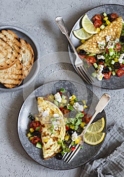 Greek salad style omelet. Delicious breakfast or snack. On a gray background