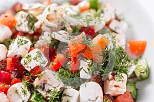 Greek salad. Vegetable with cheese, green salad, with cherry tomatoes, fetta cheese, red onion, and mixed greens photo