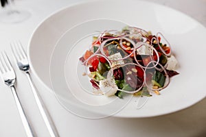 Greek salad on the white plate