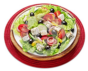 Greek salad on white plate isolated on white background photo