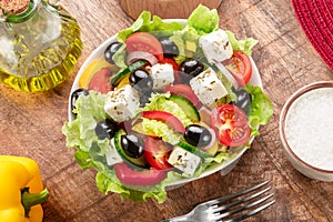 Greek salad on wooden table served and ready to eat