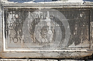 Greek script ancient letters on a rock in Ephesus, Turkey.