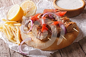 Greek souvlaki kebab with pita and vegetables close-up horizonta