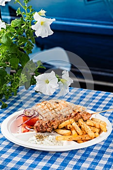 Greek souvlaki with pita bread and vegetables close-up on the table