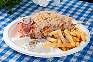 Greek souvlaki with pita bread and vegetables close-up on the table