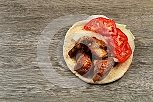 Greek souvlaki with pita bread and vegetables close-up on the table. Pork table