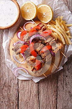 Greek souvlaki with vegetables and french fries. vertical top vi