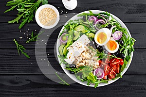 Greek style healthy breakfast bowl with oatmeal porridge and fresh vegetable salad