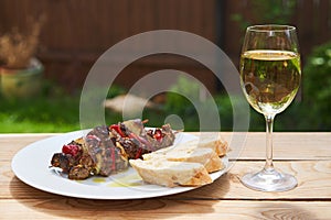 Greek style lamb souvlaki served outside in the garden with bread and gass of wine.