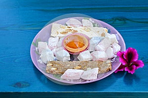 Greek sweet staff from Lefkada on turquoise table with flower