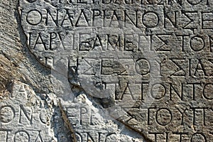 Greek Text Inscription on a rock in Delphi photo