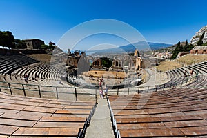Greek theater in Taormina with the Etna volcano in the background