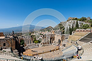 Greek theater in Taormina with the Etna volcano in the background