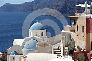 Greek traditional Orthodox Christian church in Oia village on the edge of volcano caldera of Santorini island.