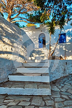 Greek village typical view with whitewashed houses and stairs. Plaka town, Milos island, Greece