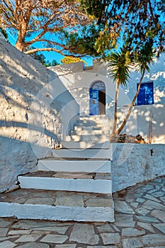 Greek village typical view with whitewashed houses and stairs. Plaka town, Milos island, Greece