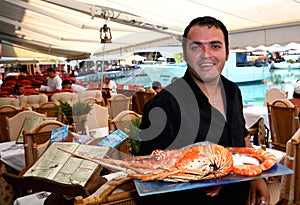 Greek waiter with lobster