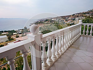 Greek white balcony with balusters sea view Athens