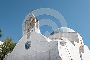 Greek whitewashed church with blue dome.