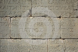 greek writing on stone wall of ancient city of Patara, Turkey