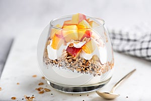 Greek yogurt parfait with granola and peach