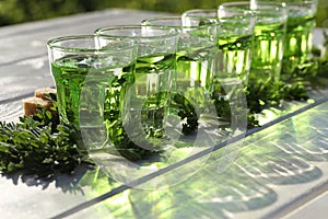 Green absinthe drink on the white background